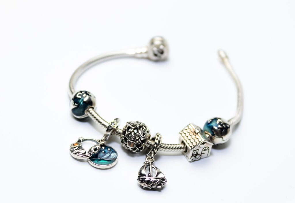 a picture of a bracelet that looks like it is made of silver with charms and